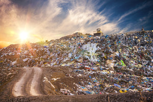 Landfill waste trash with sunset sky
